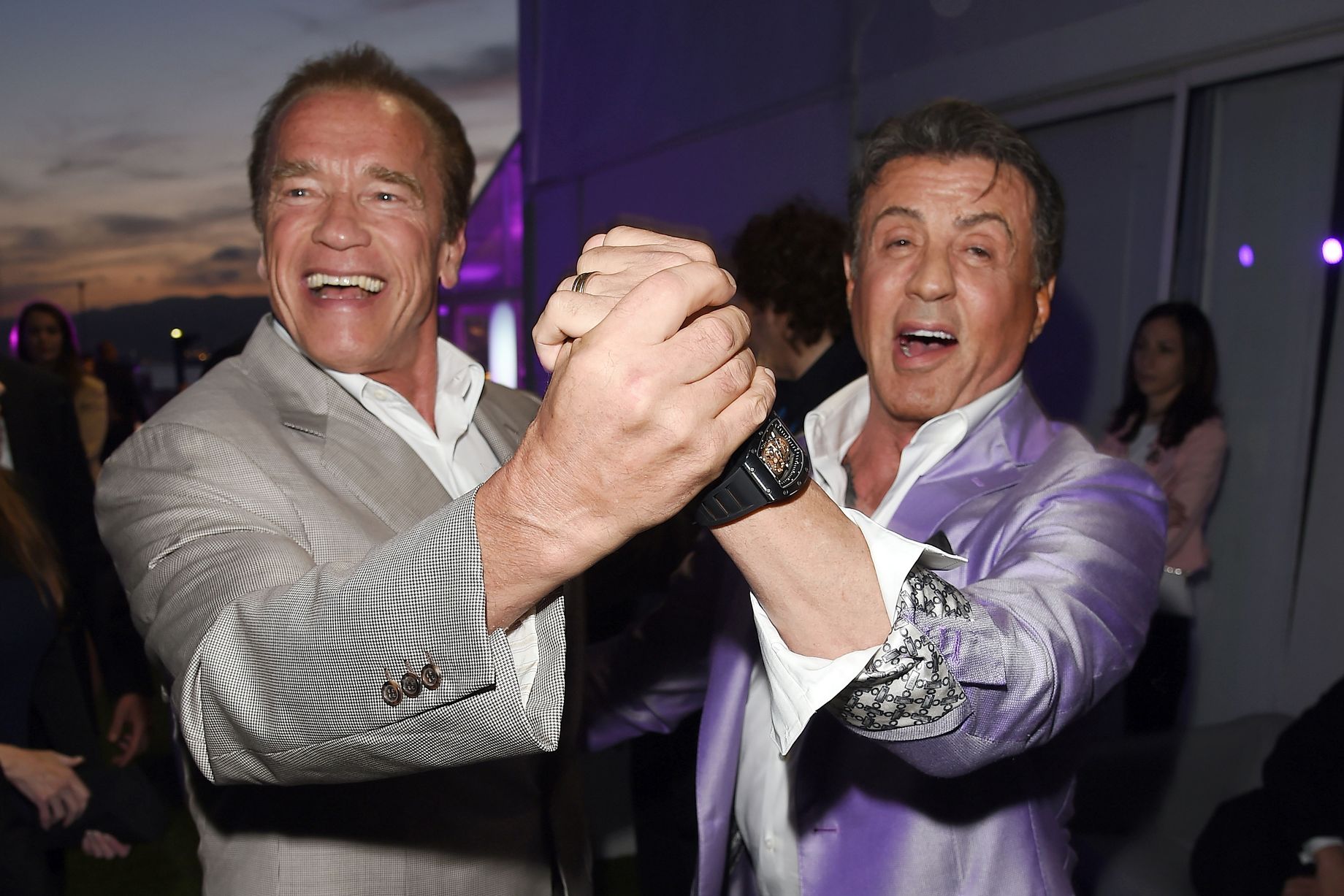 Sylvester Stallone and Arnold Schwarzenegger dance together